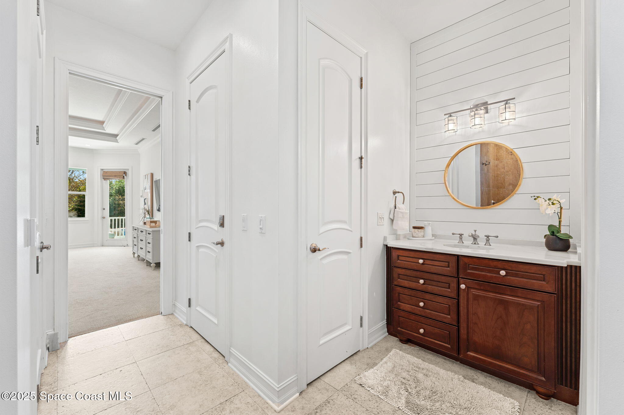 133 Windemere Place Melbourne Beach, FL 32951 - Photo 13 of 75 a bathroom with a sink a mirror and a shower