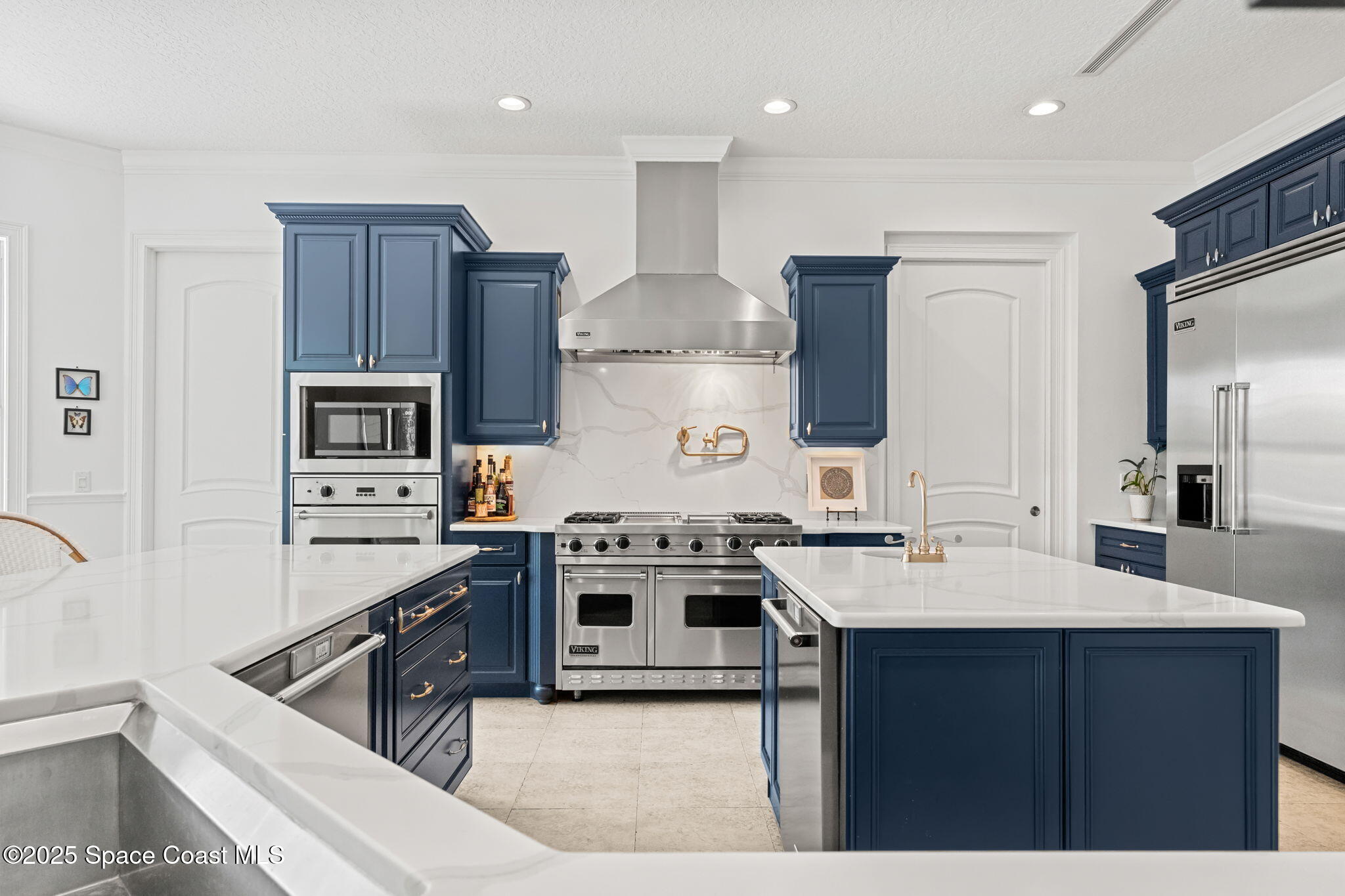 133 Windemere Place Melbourne Beach, FL 32951 - Photo 14 of 75 a kitchen with a stove a sink and a refrigerator