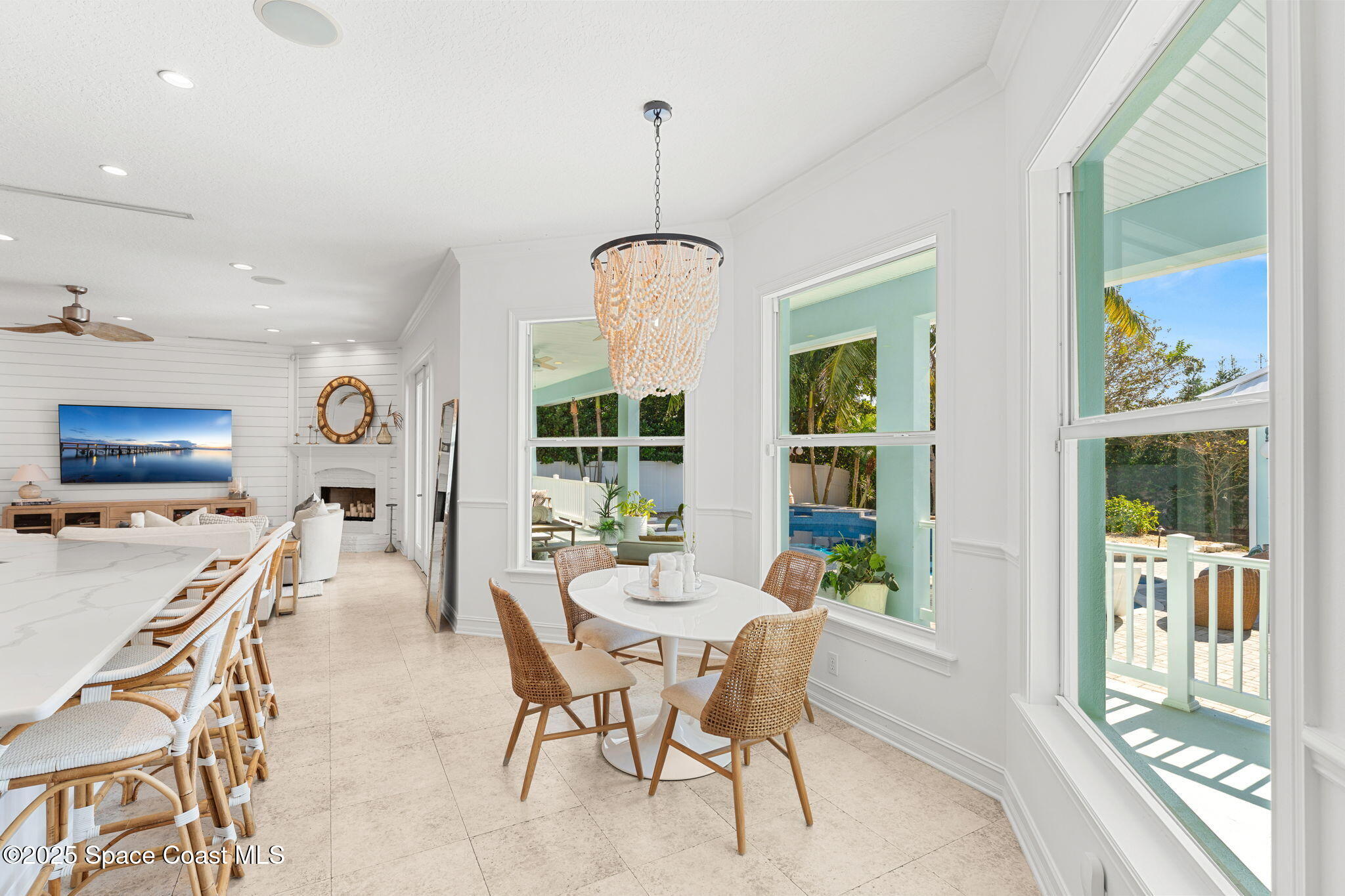 133 Windemere Place Melbourne Beach, FL 32951 - Photo 17 of 75 a dining room with furniture a flat screen tv and a large window