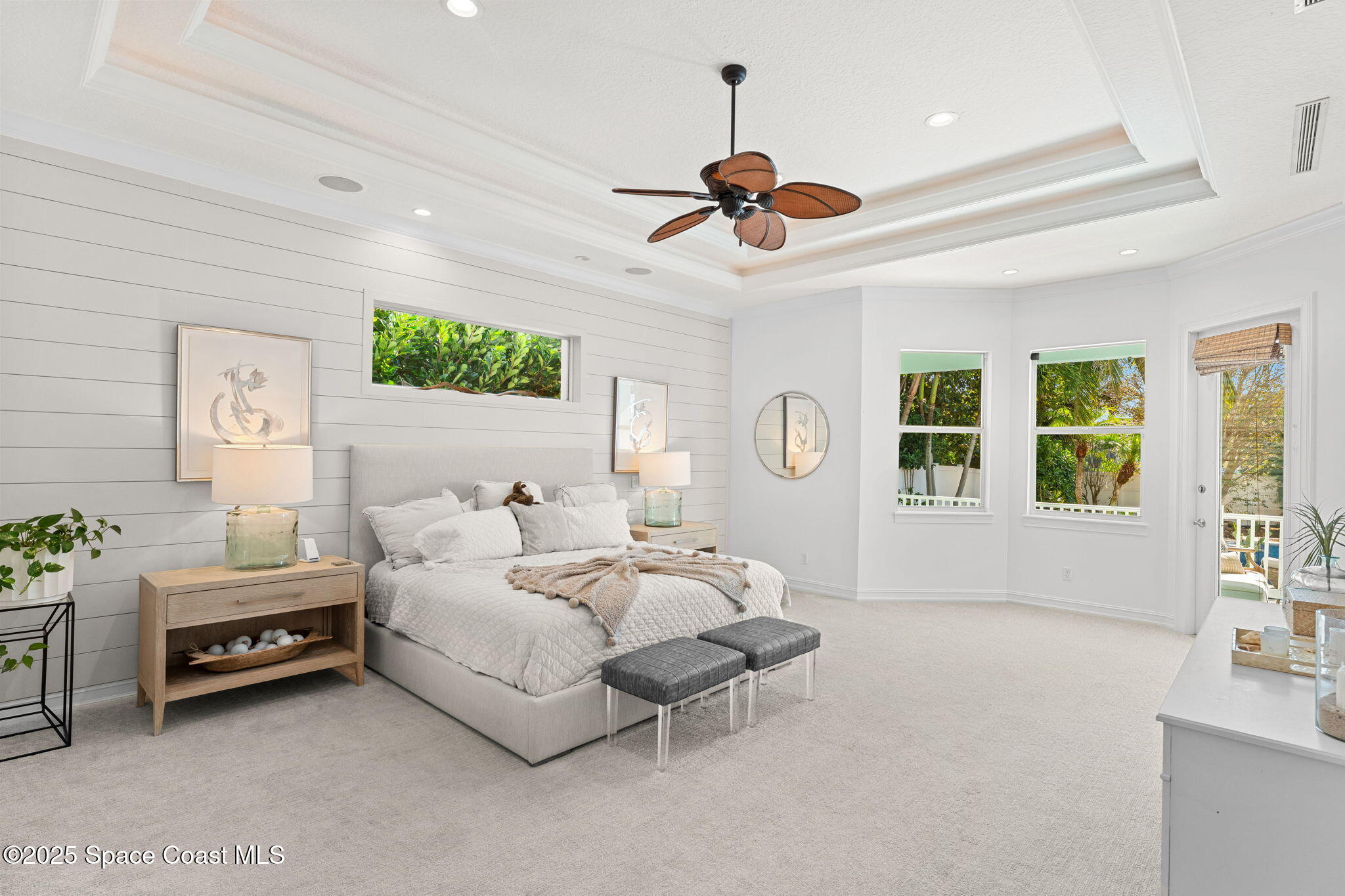 133 Windemere Place Melbourne Beach, FL 32951 - Photo 22 of 75 a spacious bedroom with a bed chandelier and a window