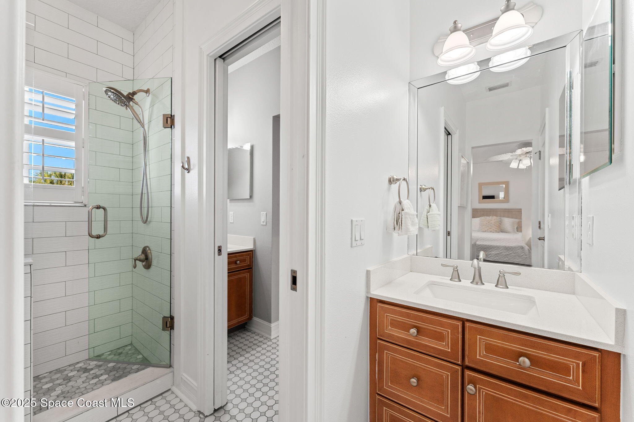 133 Windemere Place Melbourne Beach, FL 32951 - Photo 38 of 75 a bathroom with a granite countertop sink a shower and a mirror