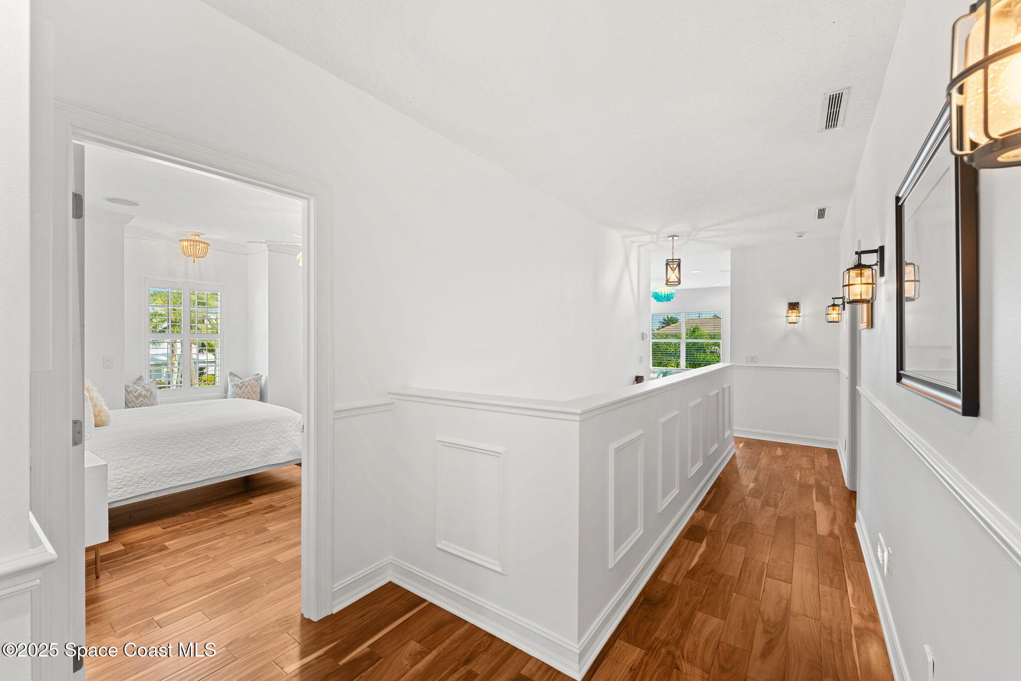 133 Windemere Place Melbourne Beach, FL 32951 - Photo 40 of 75 a hallway with a white cabinets and wooden floor