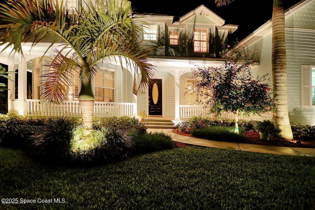 133 Windemere Place Melbourne Beach, FL 32951 - Photo 68 of 75 a front view of a house with a garden