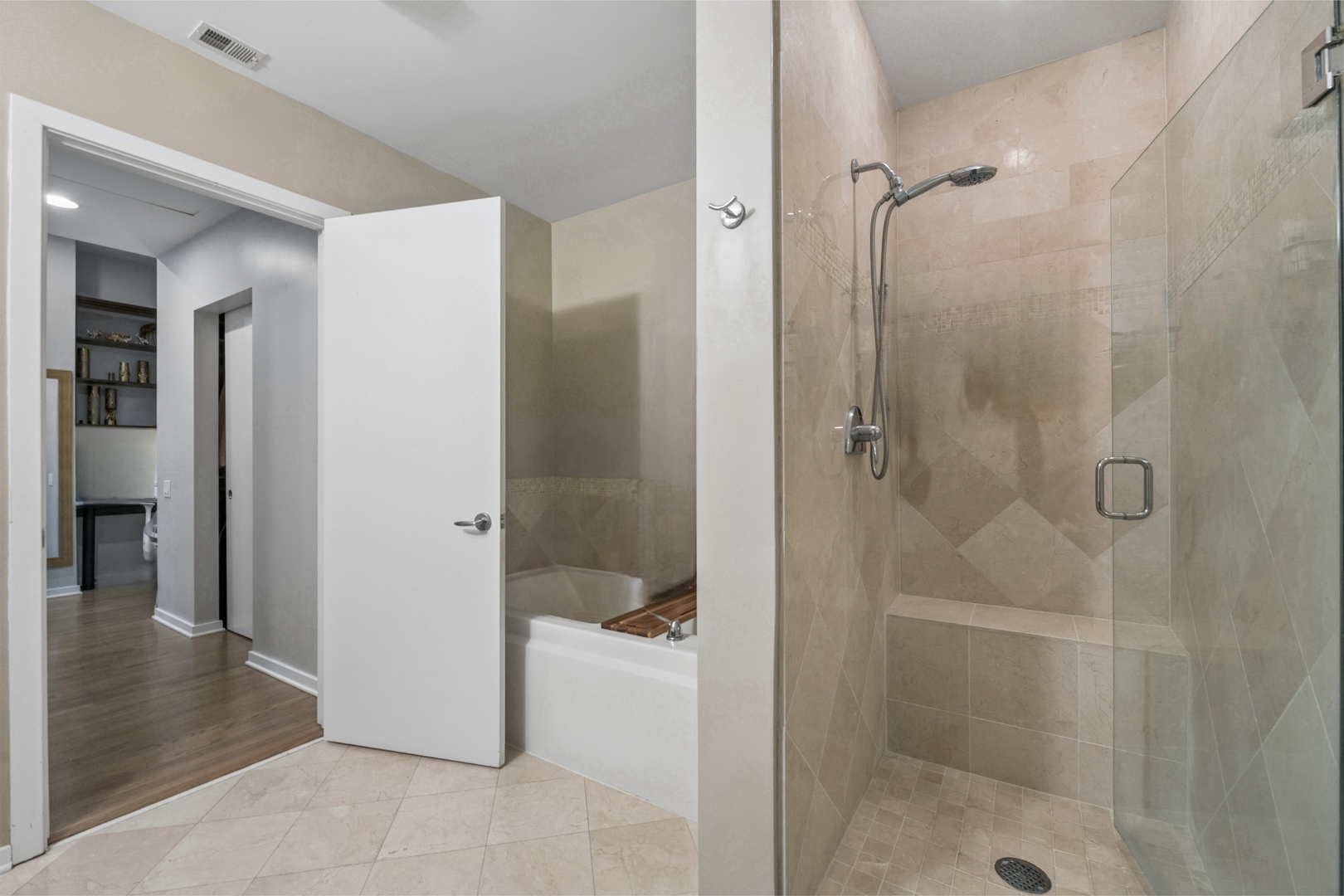 500 West Superior Street, Unit 813 Chicago, IL 60654 - Photo 12 of 18 a bathroom with a shower and a bath tub
