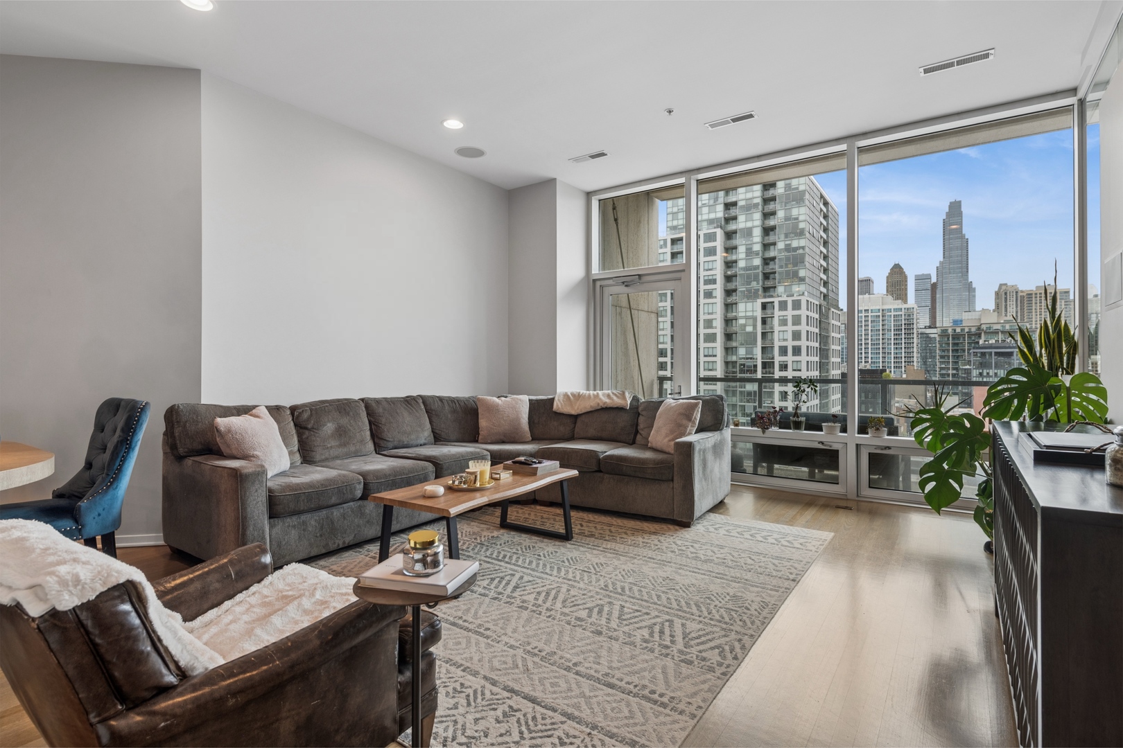 500 West Superior Street, Unit 813 Chicago, IL 60654 - Photo 6 of 18 a living room with furniture and a floor to ceiling window