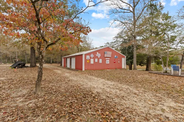 a view of a red and white house with a snow on the road