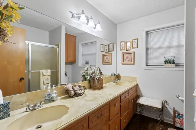 a bathroom with a granite countertop sink and a mirror