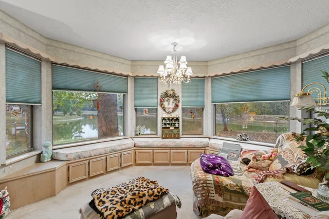 a living room with furniture and a chandelier