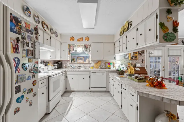 a kitchen with lots of appliances and cabinets
