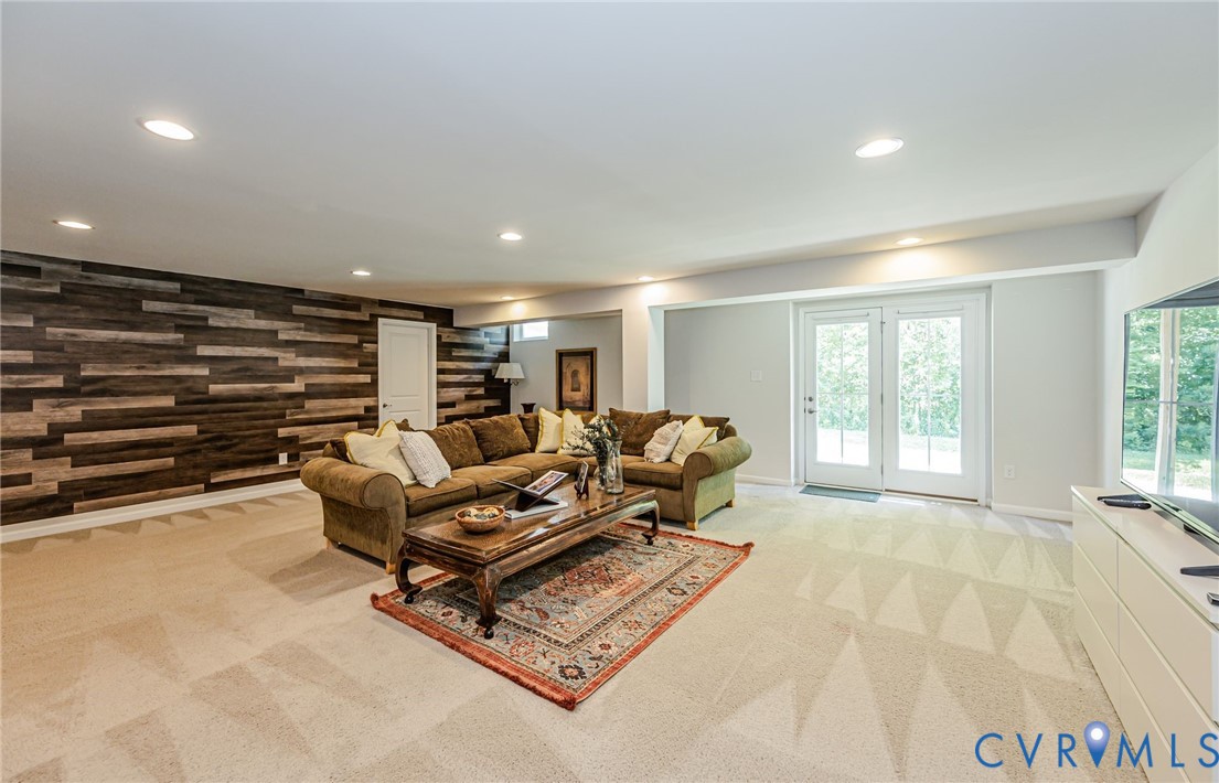 7435 Wicks Road Williamsburg, VA 23188 - Photo 63 of 82 Spacious lower-level room featuring a wood-panel a