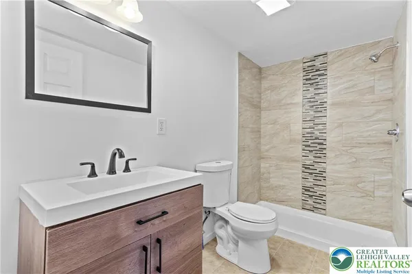 a bathroom with a sink a toilet and mirror