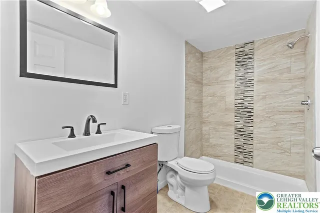 a bathroom with a sink a toilet and mirror