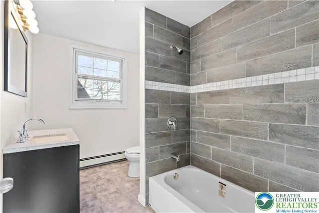 a bathroom with a tub a sink and a shower