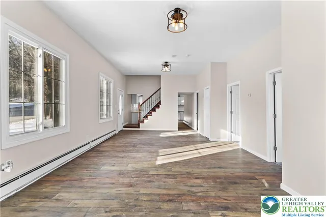 a view of an entryway with wooden floor
