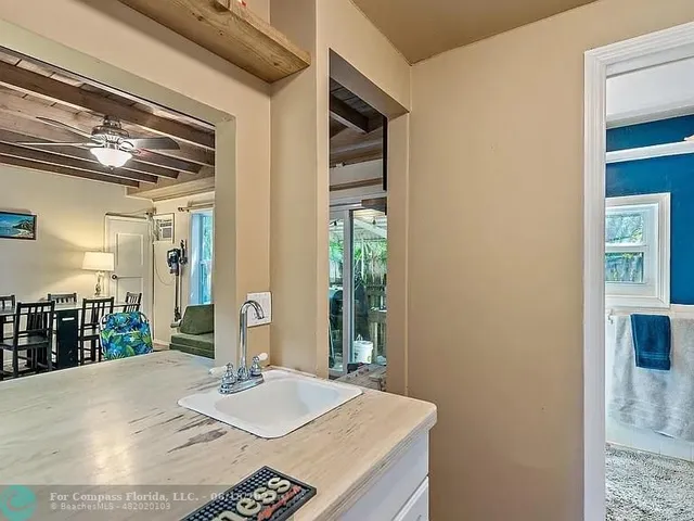 a bedroom with two beds and large windows