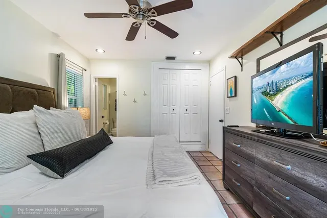 a bedroom with a bed and a mirror