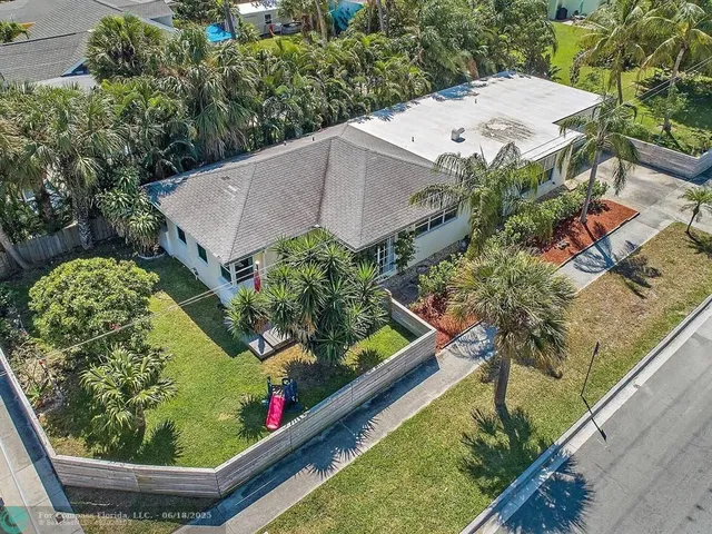 a kitchen with granite countertop a sink stainless steel appliances and cabinets