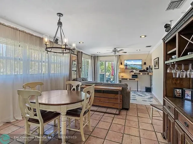a dining room with furniture a chandelier and wooden floor