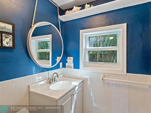 a bathroom with a sink a toilet a shower and a mirror