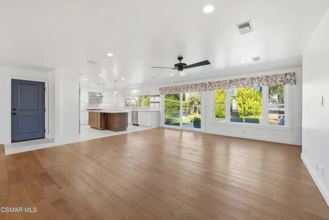 a kitchen with stainless steel appliances granite countertop a sink and a refrigerator