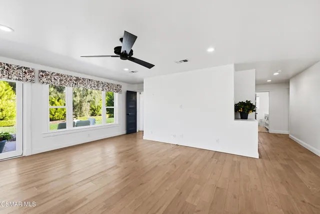 a kitchen with granite countertop white cabinets and appliances