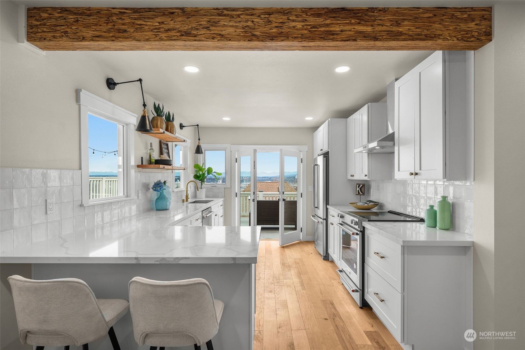 3054 37th Avenue Southwest Seattle, WA 98126 - Photo 11 of 38 a kitchen with stainless steel appliances granite countertop a stove top oven a sink a counter space and cabinets