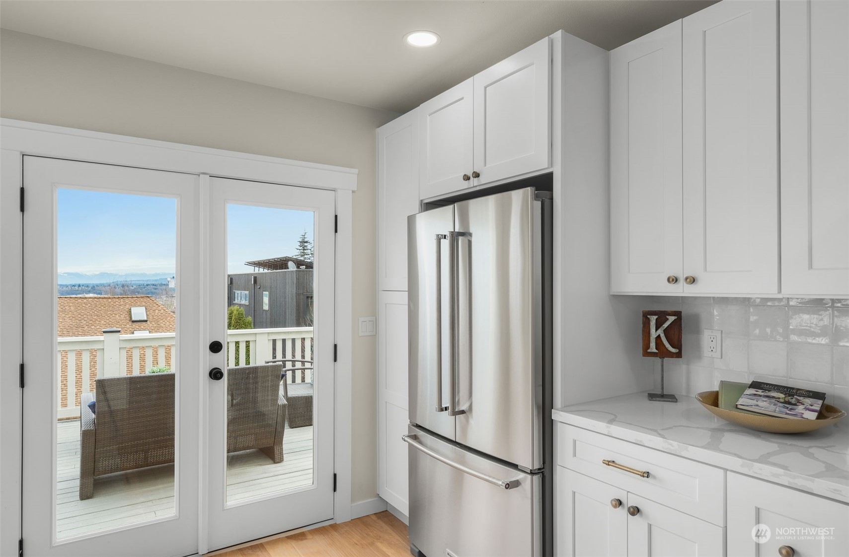 3054 37th Avenue Southwest Seattle, WA 98126 - Photo 14 of 38 a kitchen with stainless steel appliances granite countertop white cabinets and glass door
