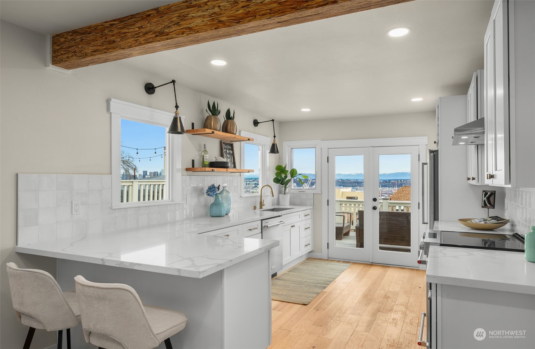 3054 37th Avenue Southwest Seattle, WA 98126 - Photo 10 of 38 a large kitchen with cabinets table and chairs