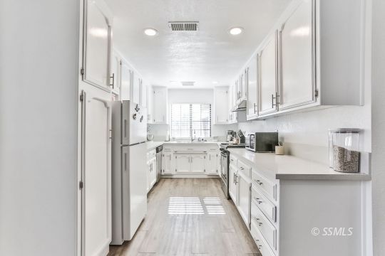 832 Walker Lane Ridgecrest, CA 93555 - Photo 11 of 23 a kitchen with white cabinets and sink