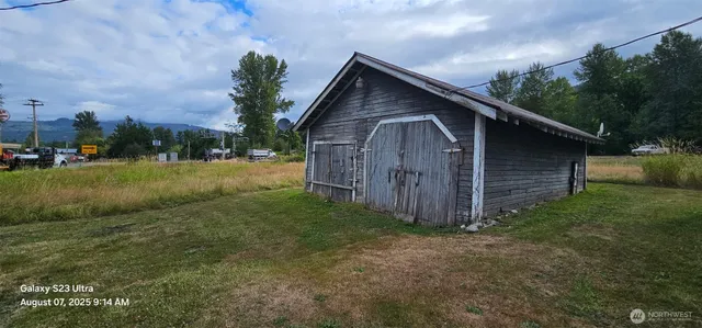 a view of swimming pool with a yard and wooden fence