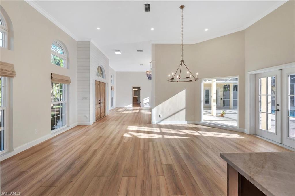 3110 70th Street Southwest Naples, FL 34105 - Photo 11 of 47 a view of a kitchen with wooden floor and a view of living room