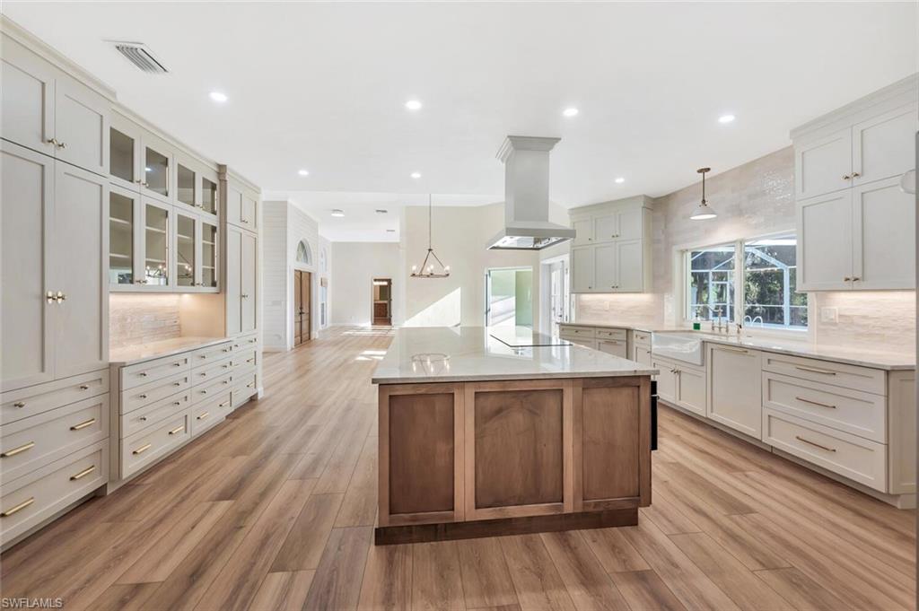 3110 70th Street Southwest Naples, FL 34105 - Photo 17 of 47 a kitchen with stainless steel appliances granite countertop wooden floors and sink