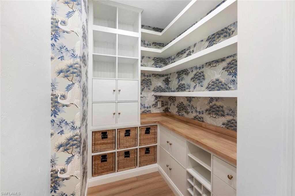 3110 70th Street Southwest Naples, FL 34105 - Photo 18 of 47 walk in closet with wooden floor