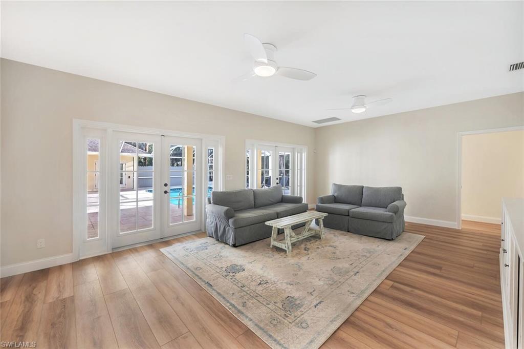 3110 70th Street Southwest Naples, FL 34105 - Photo 20 of 47 a living room with furniture and a wooden floor