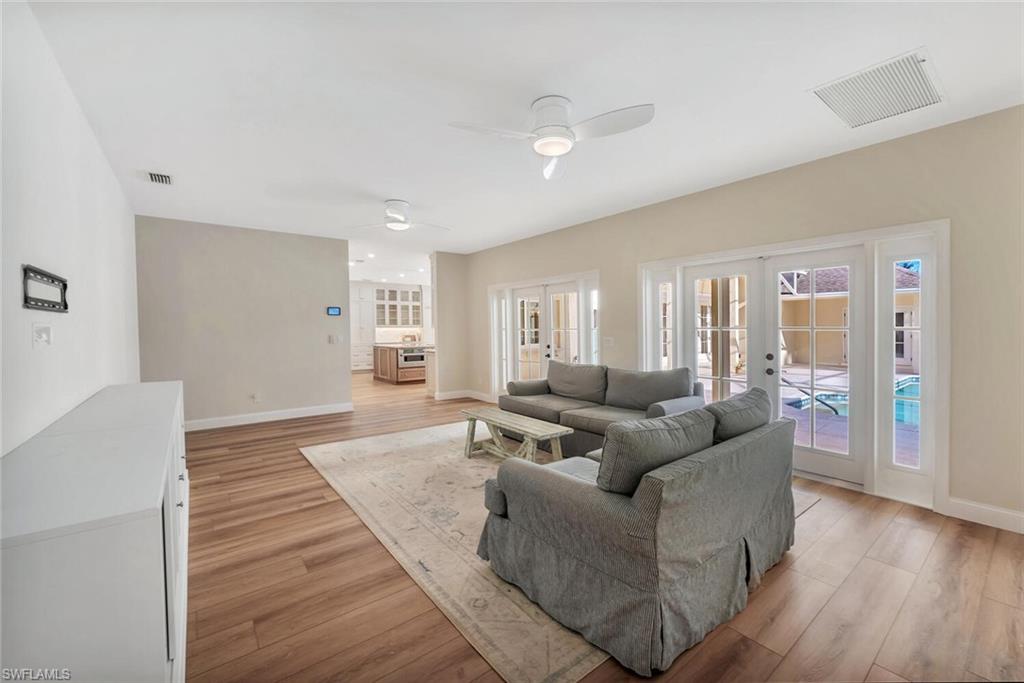 3110 70th Street Southwest Naples, FL 34105 - Photo 21 of 47 a living room with furniture and a wooden floor