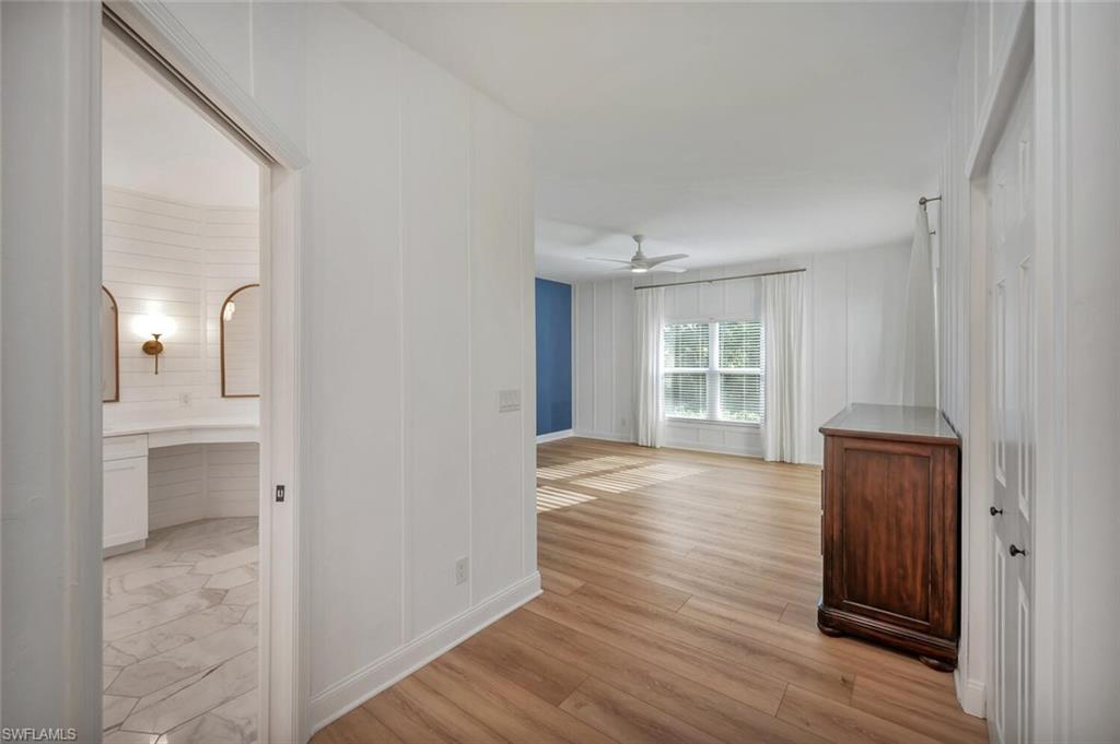 3110 70th Street Southwest Naples, FL 34105 - Photo 22 of 47 a view of an empty room with wooden floor and a window