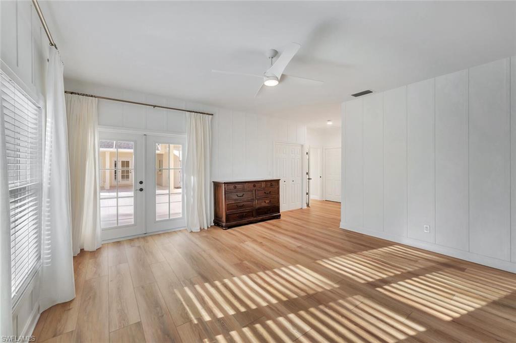 3110 70th Street Southwest Naples, FL 34105 - Photo 24 of 47 a view of empty room with wooden floor and fireplace