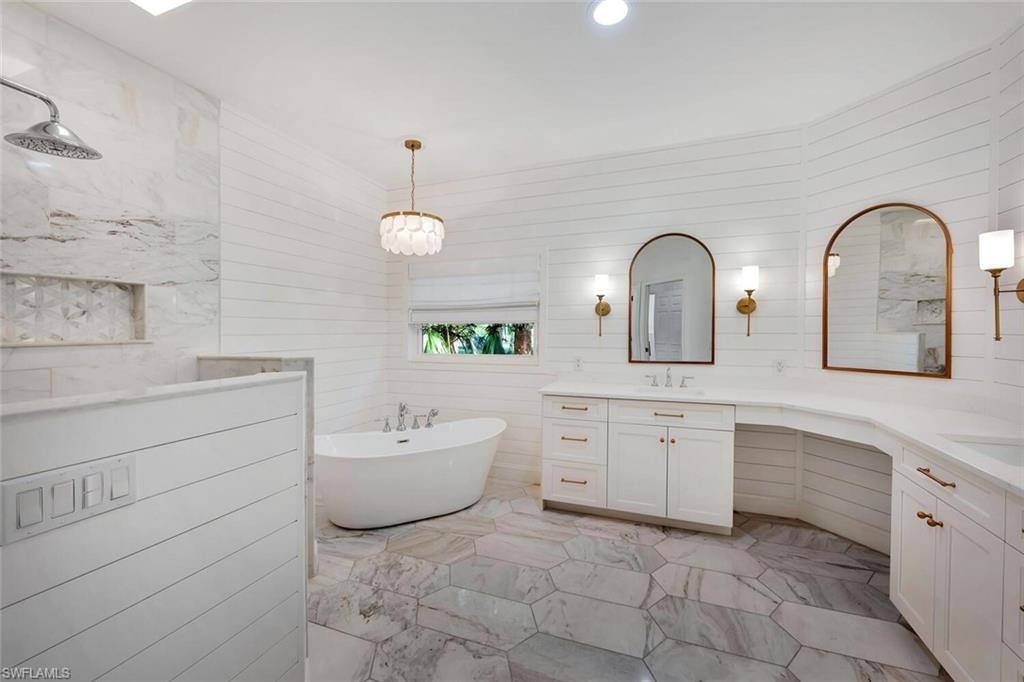 3110 70th Street Southwest Naples, FL 34105 - Photo 25 of 47 a spacious bathroom with double sink a toilet a bathtub and mirror