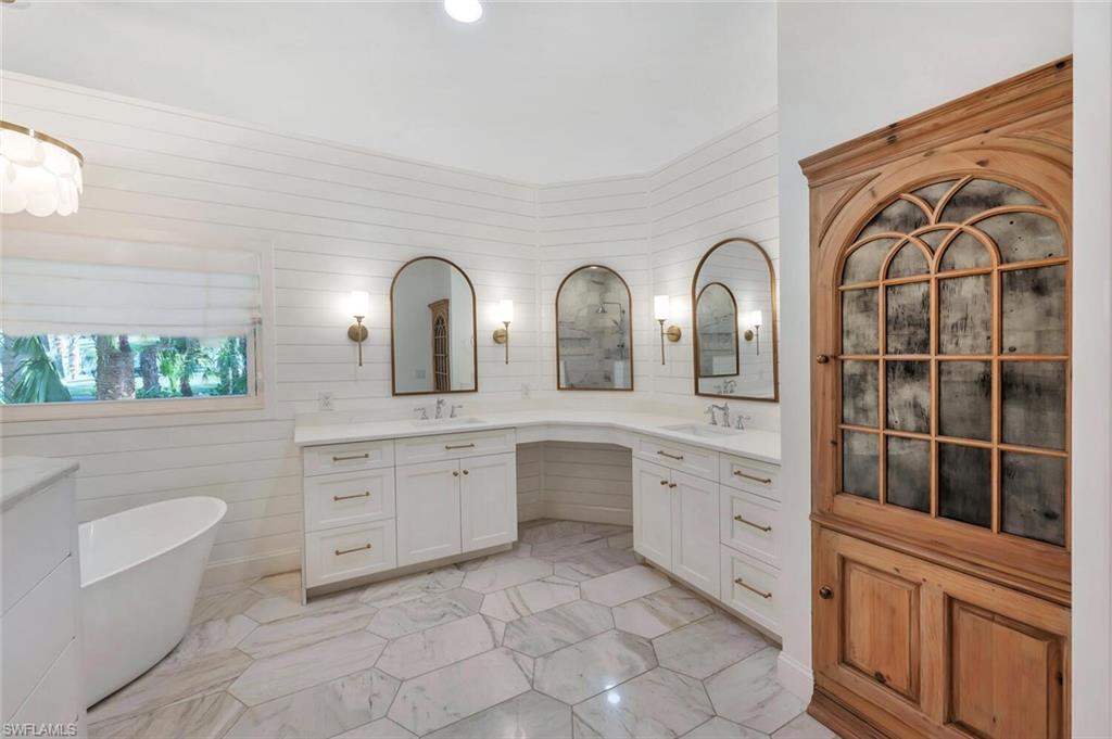 3110 70th Street Southwest Naples, FL 34105 - Photo 26 of 47 a spacious bathroom with a granite countertop sink mirror and bathtub