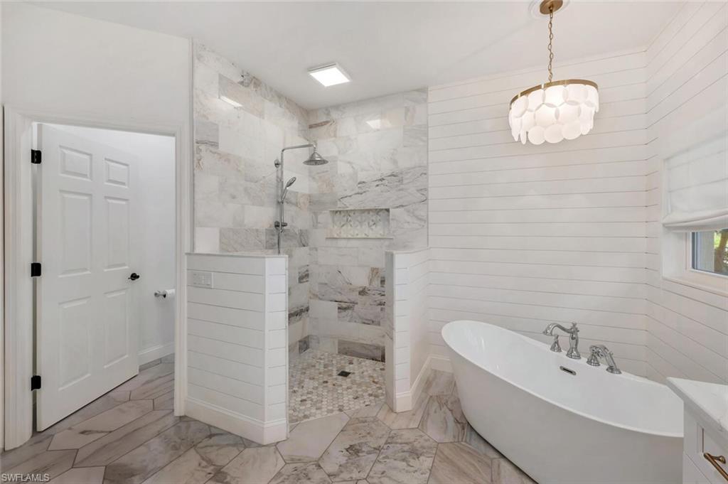 3110 70th Street Southwest Naples, FL 34105 - Photo 27 of 47 a bathroom with a bathtub sink and shower