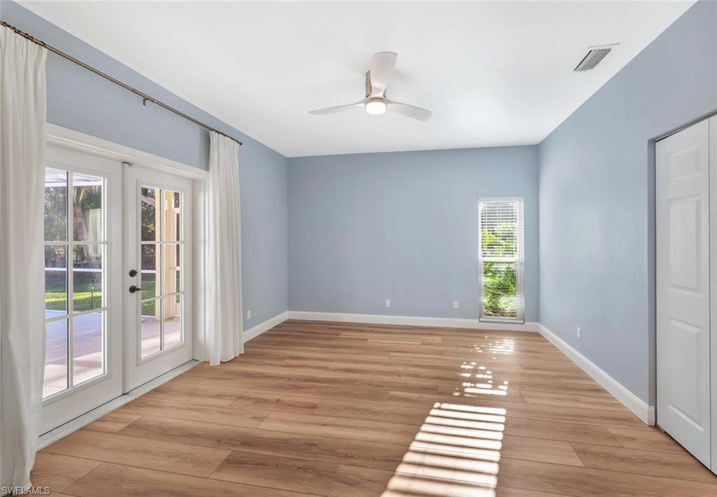 3110 70th Street Southwest Naples, FL 34105 - Photo 29 of 47 a view of an empty room with window and wooden floor