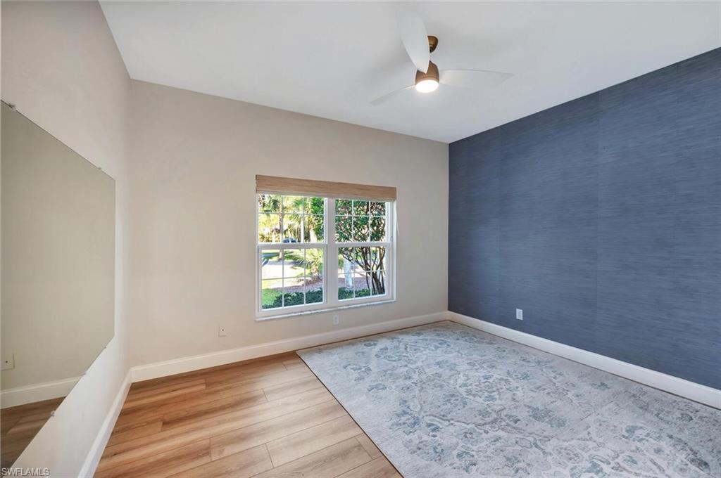 3110 70th Street Southwest Naples, FL 34105 - Photo 32 of 47 wooden floor in an empty room with a window
