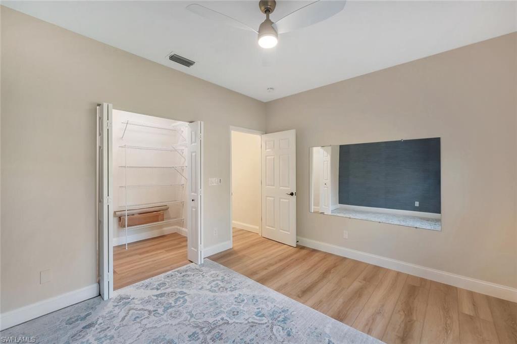 3110 70th Street Southwest Naples, FL 34105 - Photo 33 of 47 a view of an empty room with wooden floor and closet