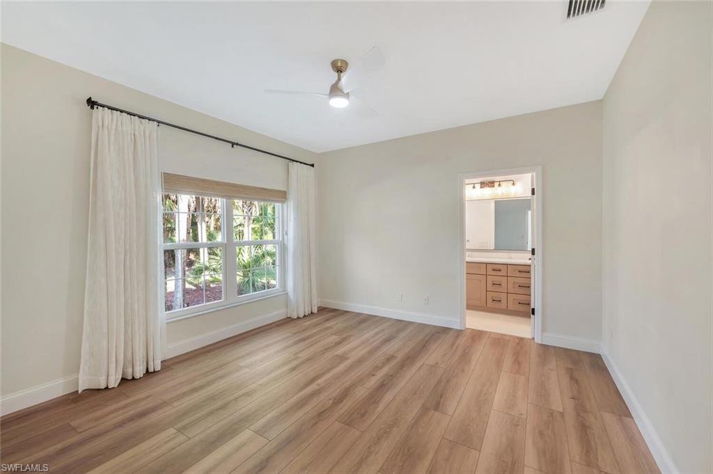 3110 70th Street Southwest Naples, FL 34105 - Photo 35 of 47 a view of an empty room with wooden floor and a window