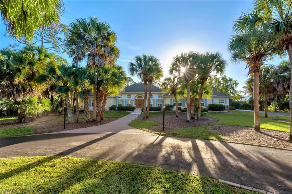 3110 70th Street Southwest Naples, FL 34105 - Photo 4 of 47 a view of a backyard with a garden