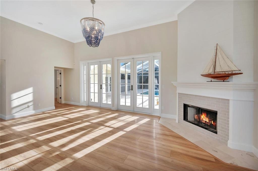 3110 70th Street Southwest Naples, FL 34105 - Photo 6 of 47 a bedroom with a bed and a chandelier