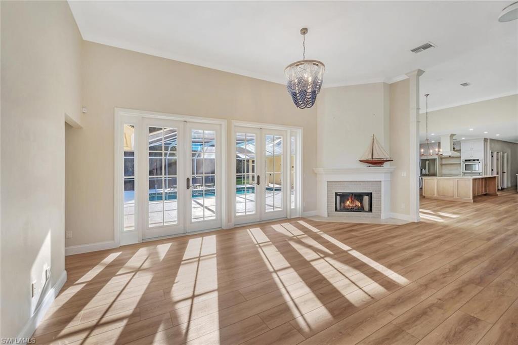 3110 70th Street Southwest Naples, FL 34105 - Photo 7 of 47 a view of an empty room with wooden floor and a window