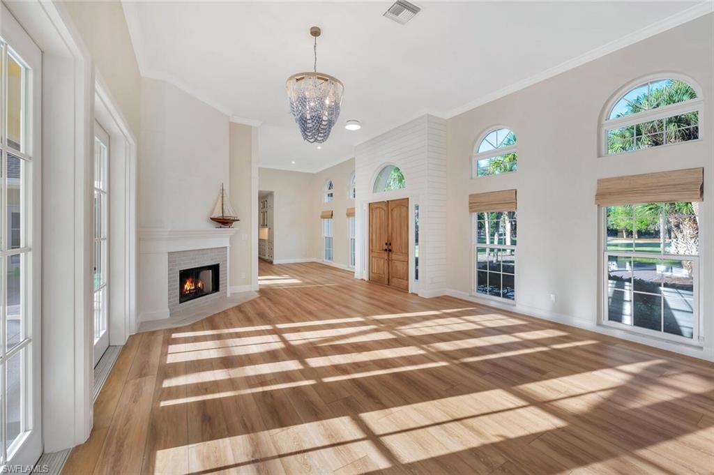 3110 70th Street Southwest Naples, FL 34105 - Photo 9 of 47 a bedroom with a bed and a fireplace