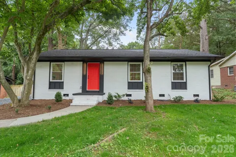 a house view with a sitting space and garden