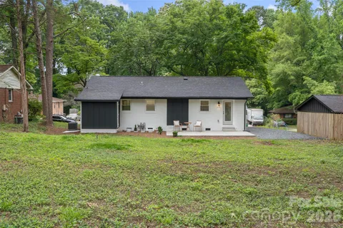 a front view of a house with yard patio and green space